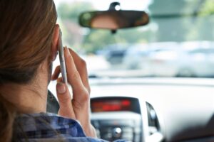 Woman using the phone while driving